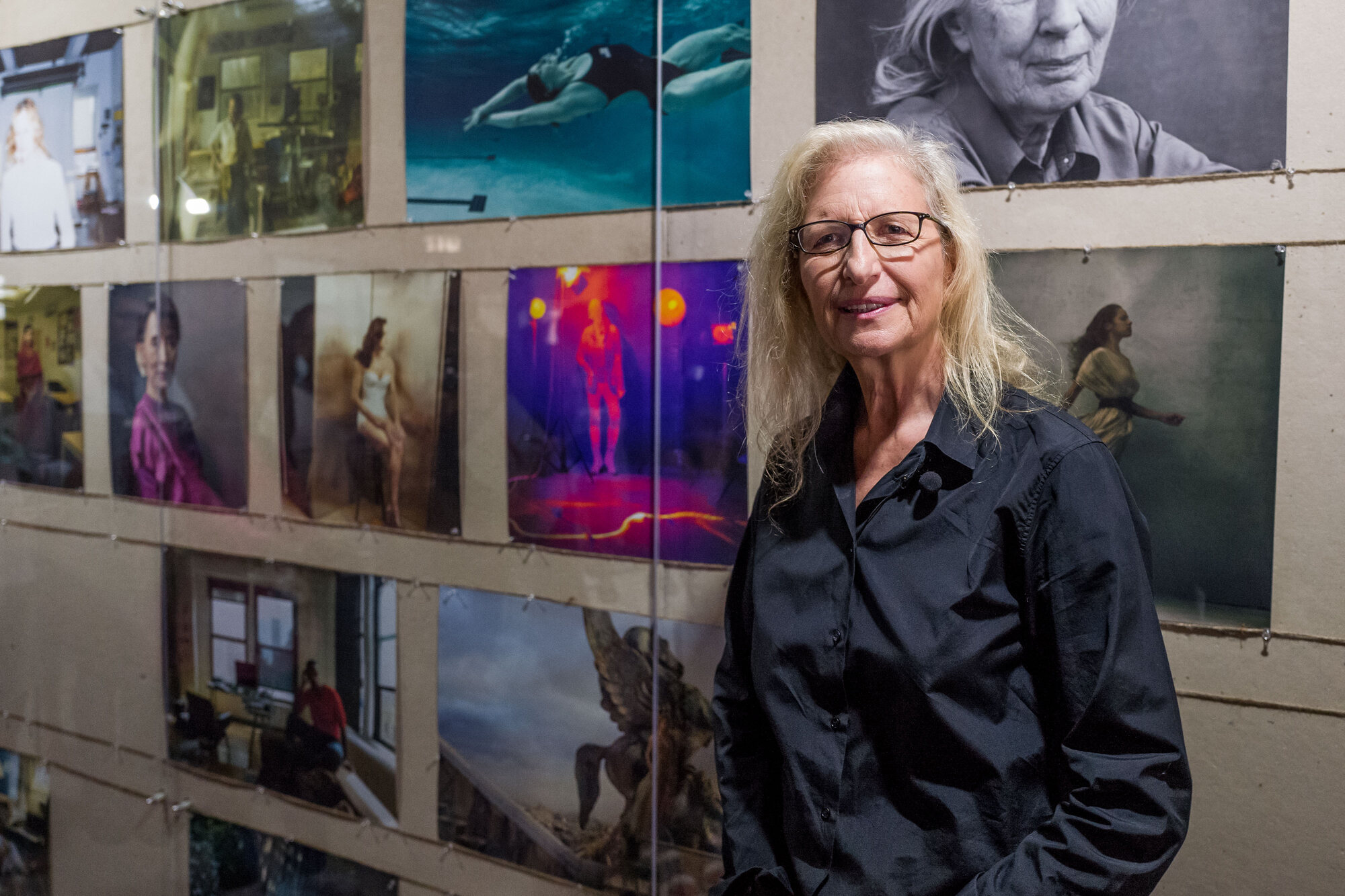 Gloria Steinem and Annie Leibovitz in front of the portrait grid at the Hong Kong exhibition
